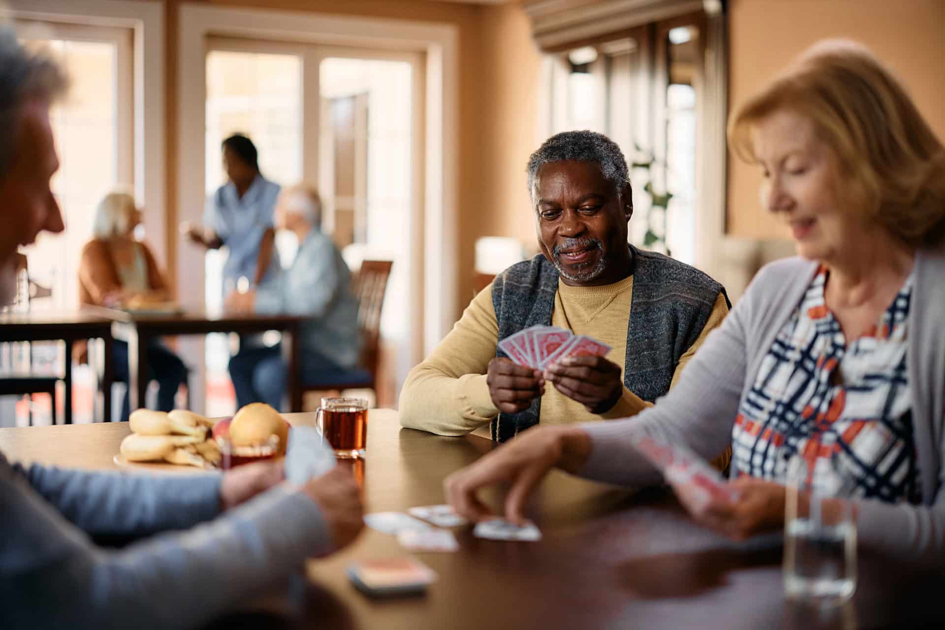 group sitting at table playing cards